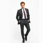 Slim-fit charcoal suit with narrow lapels and tapered trousers, paired with Chelsea boots and a bold geometric patterned tie, photographed against a clean white background with soft studio lighting, emphasizing the sharp tailoring and proportions of 1960s mod fashion