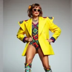 Woman wearing oversized neon blazer with exaggerated shoulder pads, bright geometric patterns, statement chunky jewelry, and leg warmers over colorful sneakers, 80s power dressing aesthetic