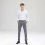 Clean minimalist fashion photoshoot featuring model wearing crisp white button-up shirt and tailored gray trousers, standing in bright white studio with natural light, showcasing modern minimalist aesthetic inspired by technological design precision