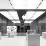 Sleek minimalist Apple Store interior with glass displays, white surfaces, and spotlit technology products arranged on varying heights, contemporary retail design