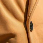 Close-up of high-quality fabric texture and expert tailoring on contemporary fashion piece, showing architectural seams and premium material details in natural lighting