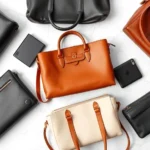 Luxury leather handbags in neutral tones—black, cognac, cream—arranged on white marble surface, showing different silhouettes and textures, professional product photography, natural studio lighting
