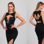 Woman wearing sleek black bodycon dress with strategic cutouts and silver holographic details, confident pose against neutral background, modern Halloween costume styling with minimal jewelry