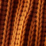 Close-up of luxurious gingerbread-toned cashmere sweater texture, warm caramel brown fiber detail, soft natural lighting, cozy aesthetic, high-quality fabric close-up, no text