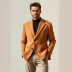 Confident man wearing oversized camel wool blazer with relaxed fit trousers, standing against neutral backdrop, soft natural lighting, contemporary menswear styling