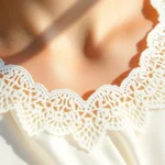 Close-up of delicate white scalloped lace blouse neckline, soft natural lighting, luxurious silk fabric, intricate curved edge detail, professional fashion photography